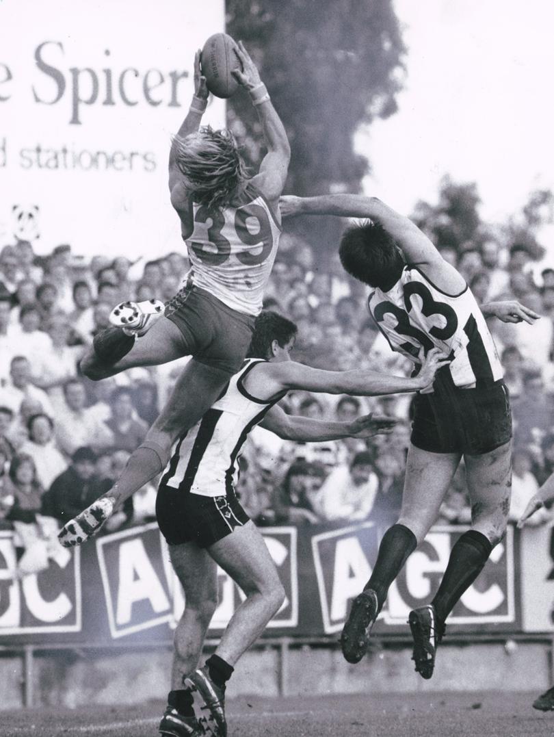 Blonde hair, tight shorts and high marks made Sydney full-forward Warwick Capper football's first pin-up boy. 