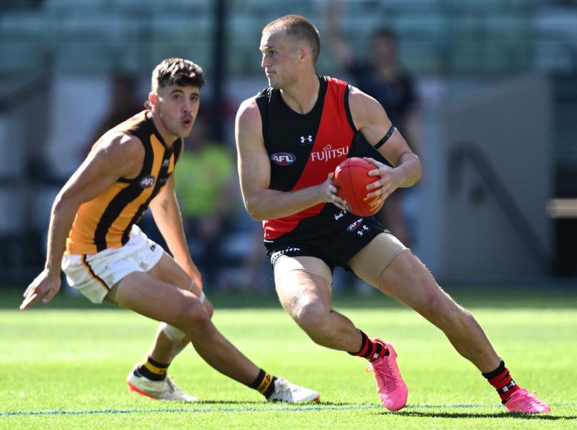 MELBOURNE, AUSTRALIA - MARCH 16: Mason Redman of the Bombers looks to pass the ball during the round one AFL match between Essendon Bombers and Hawthorn Hawks at Melbourne Cricket Ground, on March 16, 2024, in Melbourne, Australia. (Photo by Quinn Rooney/Getty Images)