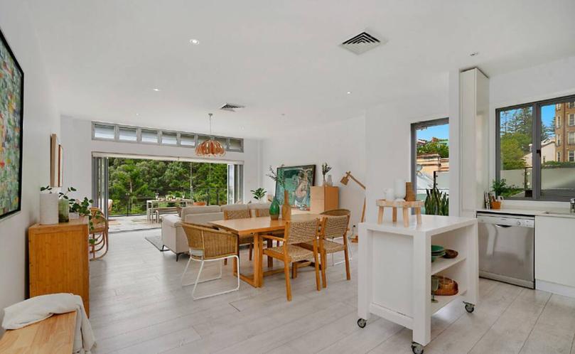 The open-plan kitchen, living and dining area has bi-fold doors leading out to the terrace.