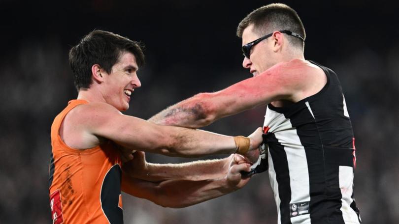 GWS defender Sam Taylor (left) refuses to back down against Magpie Mason Cox in last year's prelim. (Joel Carrett/AAP PHOTOS)