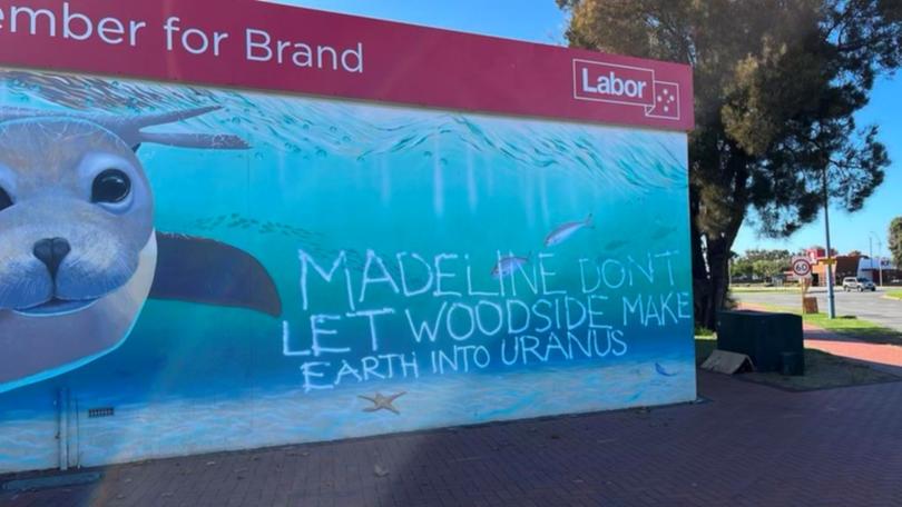 The beach-side mural of a swimming seal and fish was graffitied with the tag “Madeline dont (sic) let Woodside make earth into Uranus”.