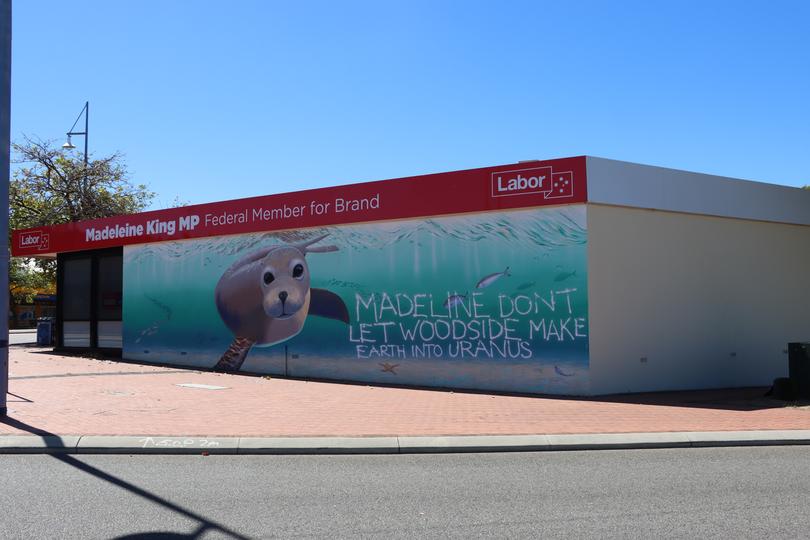 The beach-side mural of a swimming seal and fish was graffitied with the tag “Madeline dont (sic) let Woodside make earth into Uranus”.