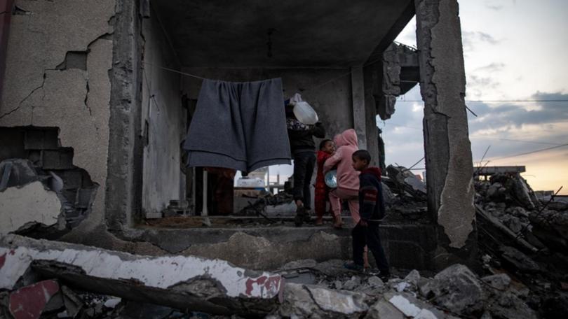 Children sheltering in a ruined house in Rafah