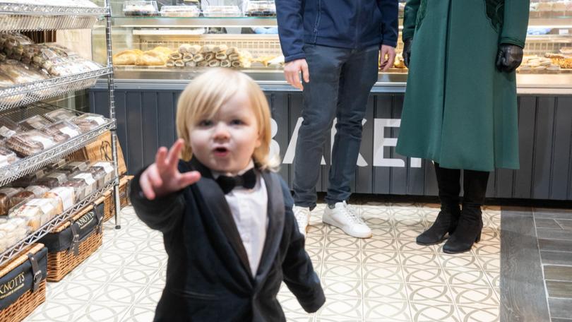 -Queen Camilla looks on at one year old Fitz William Salmon-Corrie as she visits Knotts bakery in Belfast.