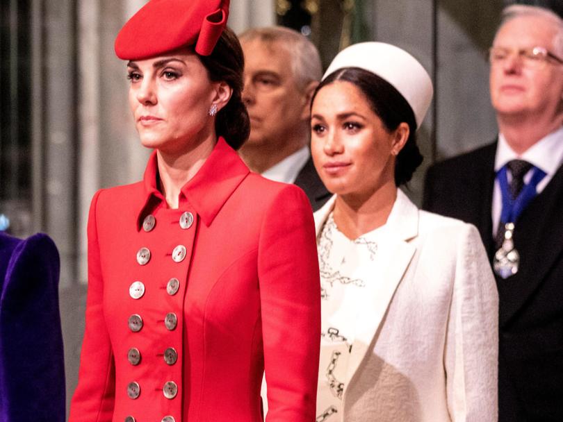Catherine, The Duchess of Cambridge stands with the Meghan, Duchess of Sussex at Westminster Abbey.