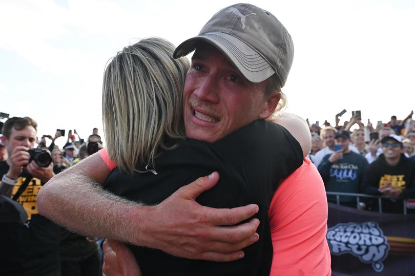 Nedd Brockmann reacts after crossing the finish line after running 4000km from Perth to Sydney, at the North Bondi Surf Life Saving Club in Sydney, Monday, October 17, 2022. 