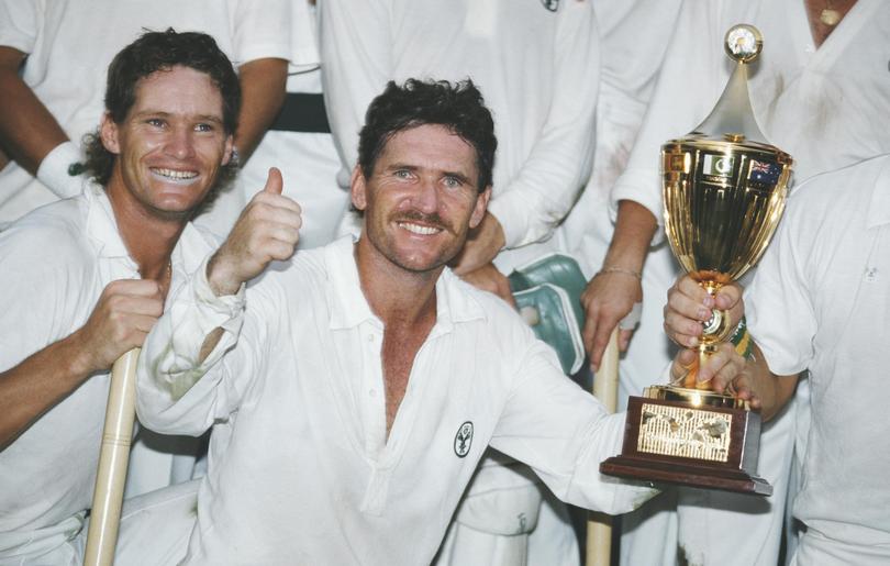 Australia captain Allan Border holds the trophy as Dean Jones (l) looks on after Australia had beaten England by 7 runs to win the 1987 Cricket World Cup Final in Calcutta, India. 