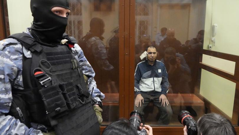 A suspect in the Crocus City Hall shooting on Friday sits in a courtroom in the Basmanny District Court in Moscow.