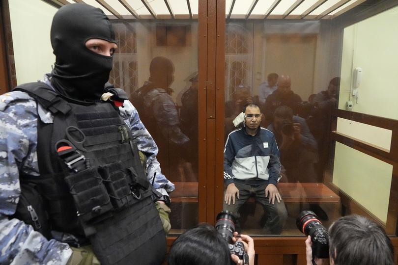 A suspect in the Crocus City Hall shooting on Friday sits in a courtroom in the Basmanny District Court in Moscow.