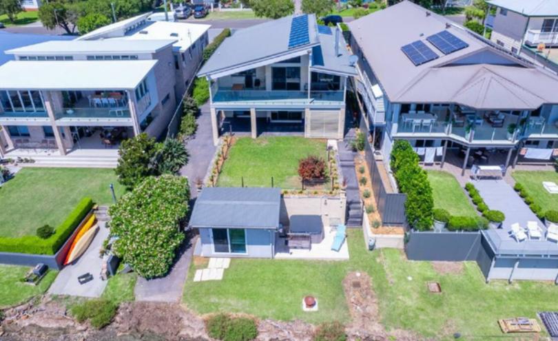 The home at 55 Horsley Road, Oak Flats includes a waterfront jacuzzi.