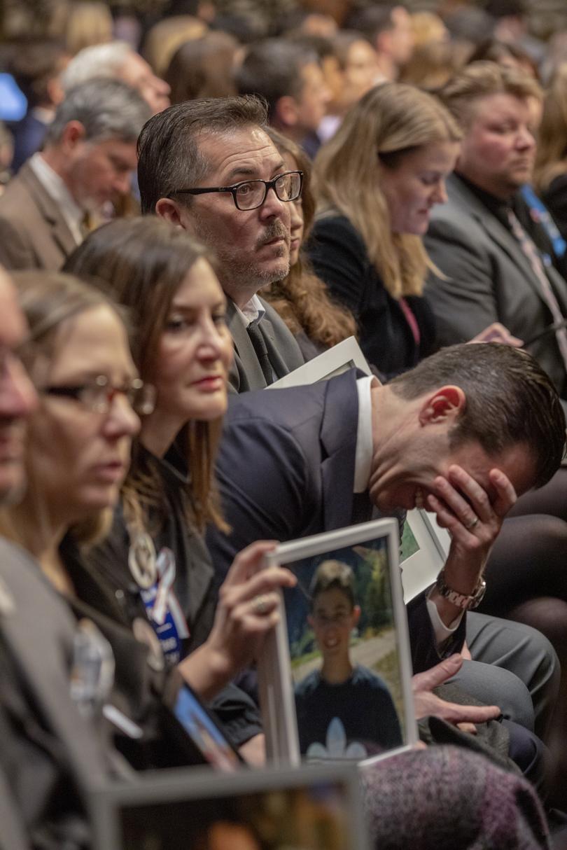 A family member laughs in reaction to a comment by Mark Zuckerberg, chief executive of Meta, among families holding portraits of victims of online abuse during a Senate Judiciary Committee hearing on online child sexual exploitation on Capitol Hill in Washington, Jan. 31, 2024. (Jason Andrew/The New York Times)