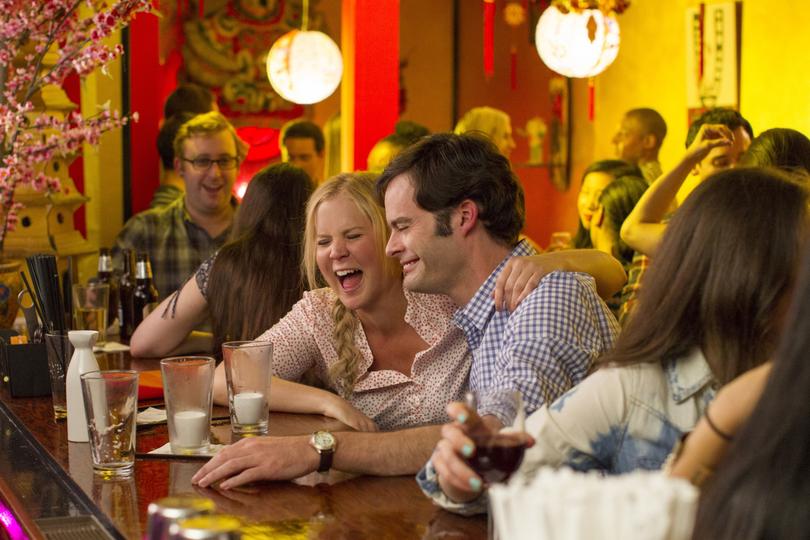 This photo provided by Universal Pictures shows, Amy Schumer , left, and Bill Hader in a scene from, "Trainwreck." The film was nominated for a Golden Globe award for best motion picture  comedy or musical on Thursday, Dec. 10, 2015. The 73rd Annual Golden Globes will be held on Jan. 10, 2016. (Mary Cybulski/Universal Pictures via AP)