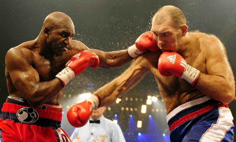 Russian WBA heavyweight champion Nikolai Valuev, right, and Evander Holyfield from the United States exchange punches during their WBA heavyweight boxing world championships fight at the Hallenstadion venue in Zurich, Switzerland, Saturday, Dec. 20, 2008. (AP Photo/Keystone, Walter Bieri)