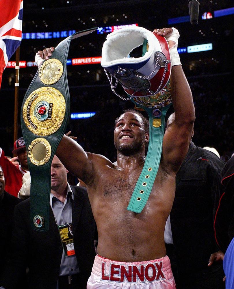 ** FILE ** In this June 21, 2003 file photo, Lennox Lewis holds aloft his champions belts following his WBC/IBO heavyweight championship bout against challenger Vitali Klitschko in Los Angeles. The English-born Lewis headlined the 2009 International Boxing Hall of Fame induction class announced Tuesday Dec. 9, 2008.  (AP Photo/Mark J. Terrill, File)