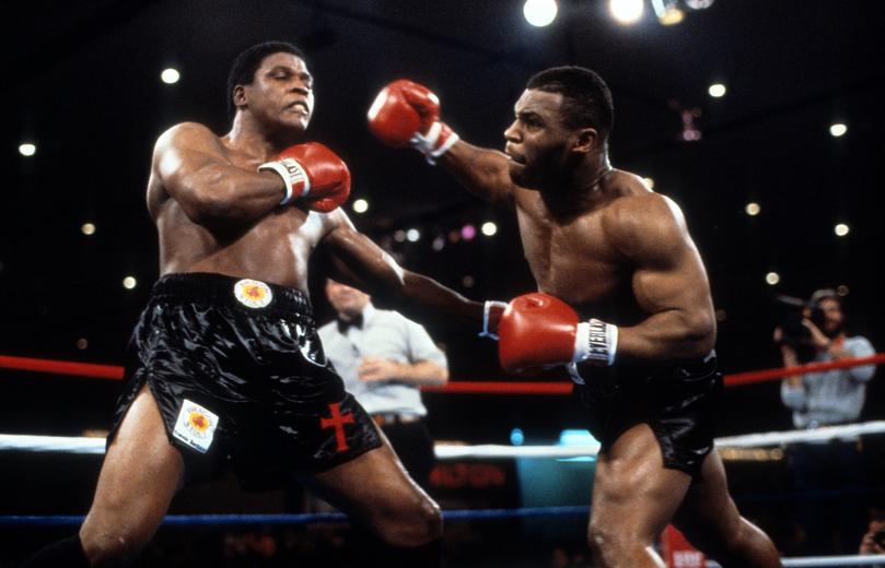 LAS VEGAS - NOVEMBER 22,1986:  Mike Tyson (R) throws a punch against Trevor Berbick during the fight at Hilton Hotel in Las Vegas, Nevada. Mike Tyson won the WBC heavyweight title by a TKO 2. (Photo by: The Ring Magazine via Getty Images)