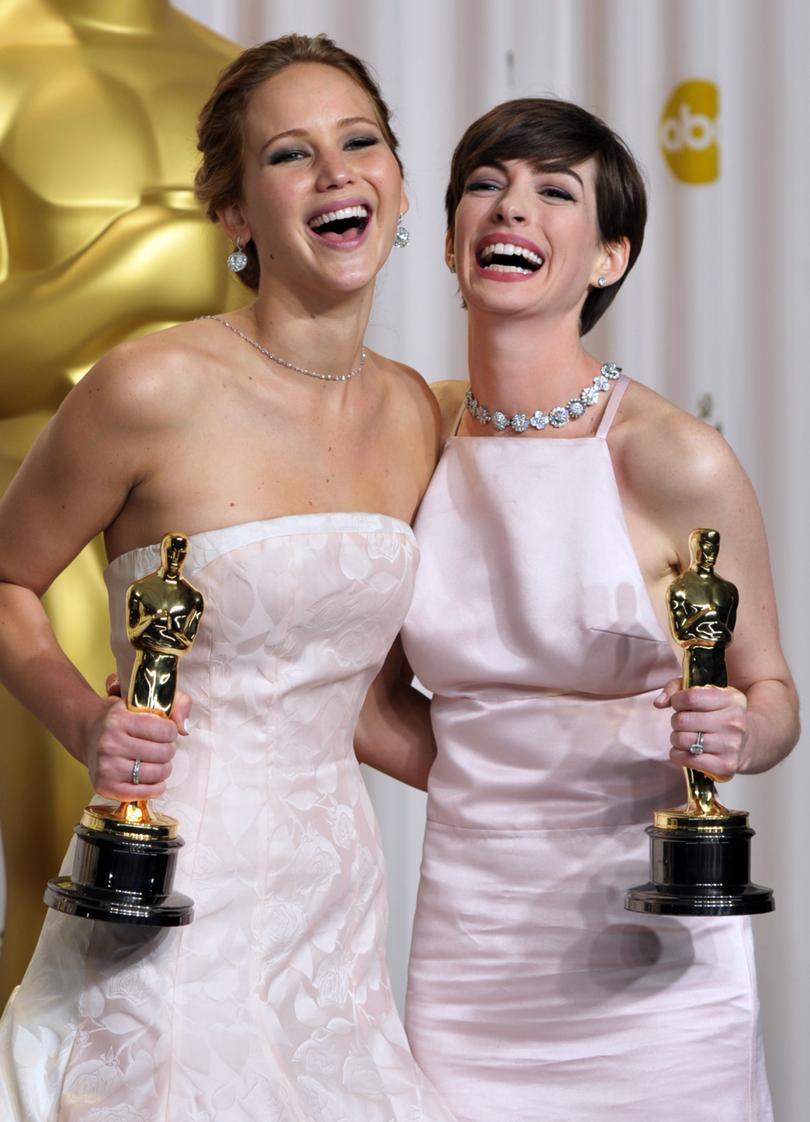 Jennifer Lawrence, with her award for best actress in a leading role for "Silver Linings Playbook," and Anne Hathaway with her award for best actress in a supporting role for "Les Miserables," pose during the Oscars at the Dolby Theatre on Sunday Feb. 24, 2013, in Los Angeles. (Photo by John Shearer/Invision/AP)
