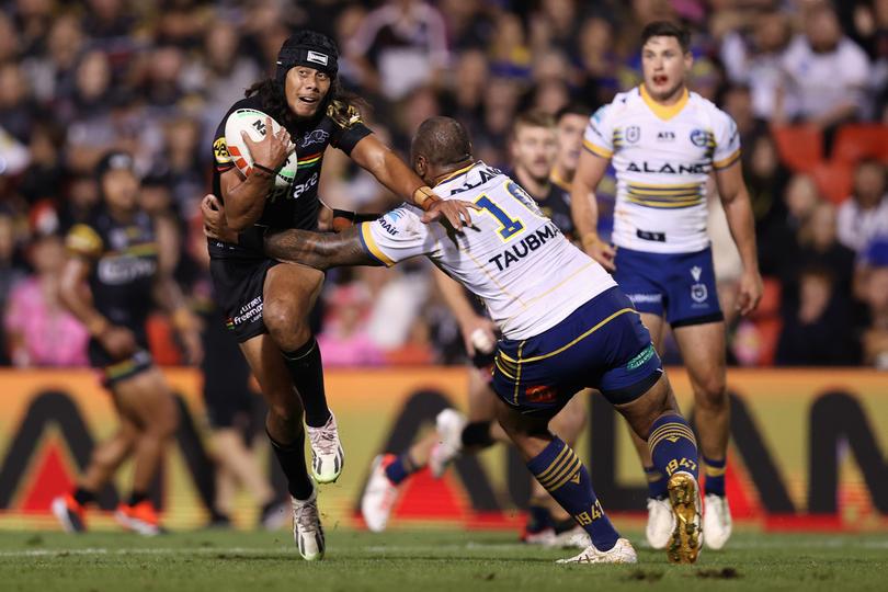 PENRITH, AUSTRALIA - MARCH 15: Jarome Luai of the Panthers is tackled by Junior Paulo of the Eels during the round two NRL match between Penrith Panthers and Parramatta Eels at BlueBet Stadium, on March 15, 2024, in Penrith, Australia. (Photo by Jason McCawley/Getty Images)