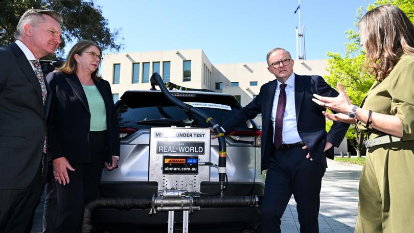 (L-R) Australian Energy Minister Chris Bowen, Australian Transport Minister Catherine King and Australian Prime Minister Anthony Albanese take a look at a car undergoing the Real-World Testing of Vehicle Efficiency program outside Parliament House in Canberra, Wednesday, October 18, 2023. (AAP Image/Lukas Coch) NO ARCHIVING