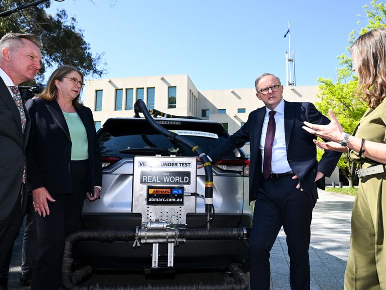 (L-R) Australian Energy Minister Chris Bowen, Australian Transport Minister Catherine King and Australian Prime Minister Anthony Albanese take a look at a car undergoing the Real-World Testing of Vehicle Efficiency program outside Parliament House in Canberra, Wednesday, October 18, 2023. (AAP Image/Lukas Coch) NO ARCHIVING