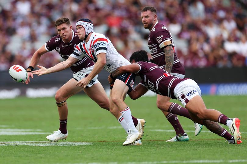 SYDNEY, AUSTRALIA - MARCH 17: Luke Keary of the Roosters passes as he is tackled during the round two NRL match between Manly Sea Eagles and Sydney Roosters at 4 Pines Park, on March 17, 2024, in Sydney, Australia. (Photo by Cameron Spencer/Getty Images)