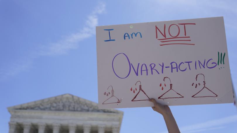 FILE - An abortion-rights activist holds a sign reading "I am not Ovary-Acting," during a protest outside of the U.S. Supreme Court, on June 28, 2022, in Washington. A new poll finds a growing percentage of Americans calling out abortion or womenâ??s rights as priorities for the government in the wake of the Supreme Courtâ??s decision to overturn Roe v. Wade, especially among Democrats and those who support abortion access. (AP Photo/Mariam Zuhaib, File)