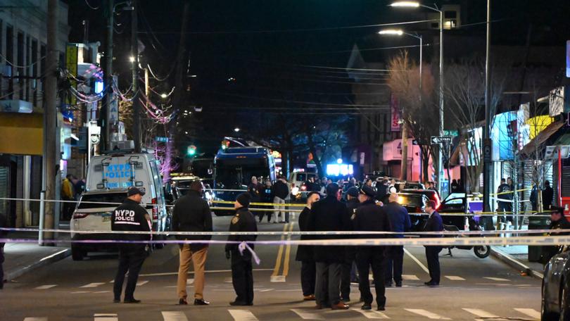 Investigators scour the area of Mott Avenue for evidence following the fatal shooting in Queens. 