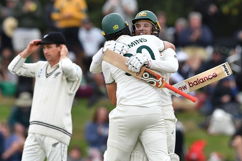 Australia's Pat Cummins (C) and Alex Carey (R) celebrate their victory on day four of the second Test cricket match between New Zealand and Australia at Hagley Oval in Christchurch on March 11, 2024. (Photo by Sanka Vidanagama / AFP)