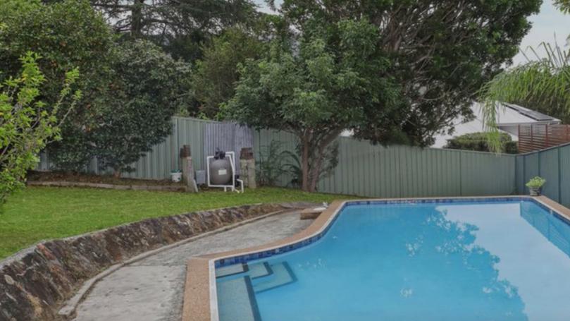 The property features a backyard and pool.