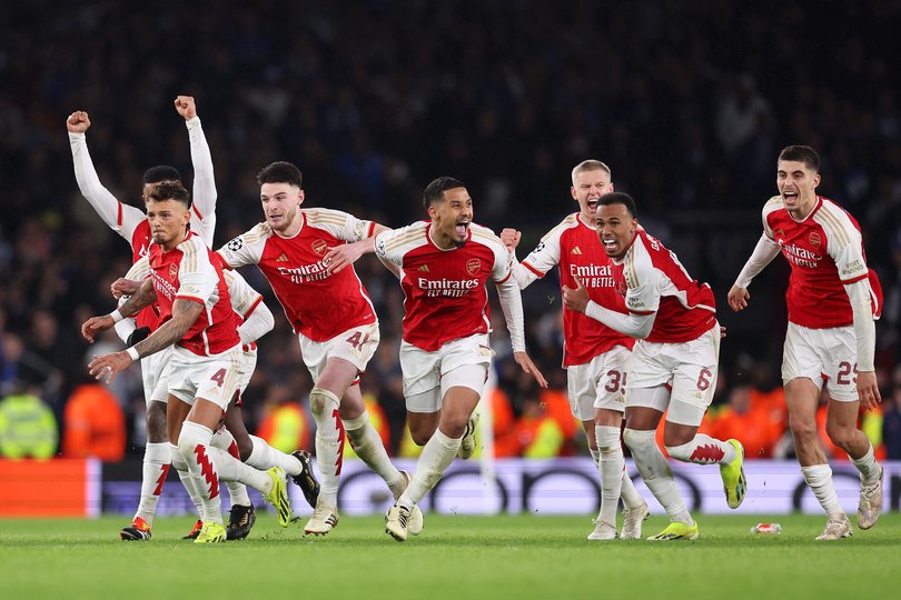 LONDON, ENGLAND - MARCH 12: The players of Arsenal celebrate as David Raya of Arsenal (not pictured) makes the match-winning save from the fourth penalty from Galeno of FC Porto (not pictured) in the penalty shoot out during the UEFA Champions League 2023/24 round of 16 second leg match between Arsenal FC and FC Porto at Emirates Stadium on March 12, 2024 in London, England. (Photo by Julian Finney/Getty Images)