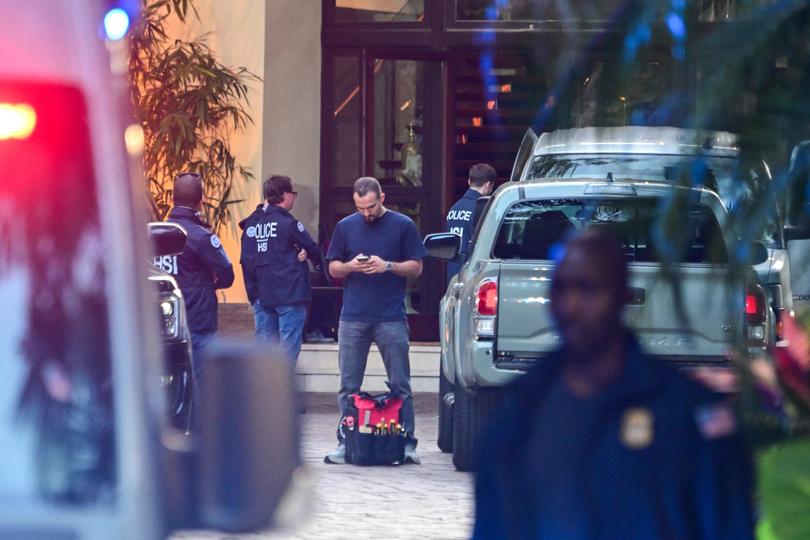 Homeland Security Investigation agents are seen at the entrance of US producer and musician Sean "Diddy" Combs's home at Star Island in Miami Beach on March 25, 2024. Homes belonging to Sean "Diddy" Combs were being raided by federal agents, media reported on March 25, with the US hip hop mogul at the center of sex trafficking and sex assault lawsuits. (Photo by GIORGIO VIERA / AFP)