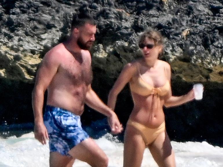 Taylor Swift and Travis Kelce were spotted cooling off in the sea after soaking up the sun on holiday in the Bahamas.