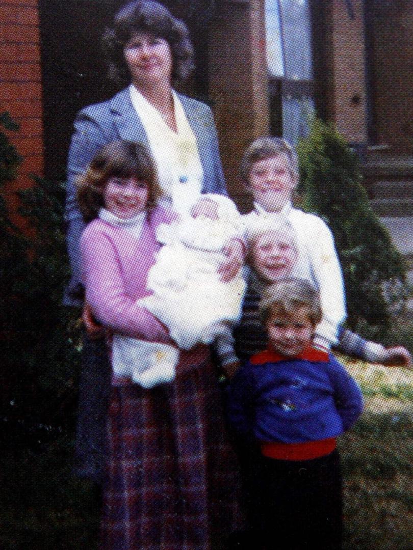 Surfer Mick Fanning copy photos from his book Surf for your life. "Family photo in front of our house in Penrith. Rachel is holding me, while Sean, Edward and Peter are nicely lined up in front of Mum". Picture: Mark Evans