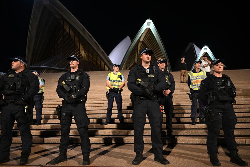 Police look on to participants of a Free Palestine rally  outside the Sydney Opera House in Sydney, Monday, October 9, 2023. Israel has pounded the Palestinian enclave of Gaza, killing hundreds of people in retaliation for one of the bloodiest attacks in its history when Islamist group Hamas killed 700 Israelis and abducted dozens more. (AAP Image/Dean Lewins) NO ARCHIVING