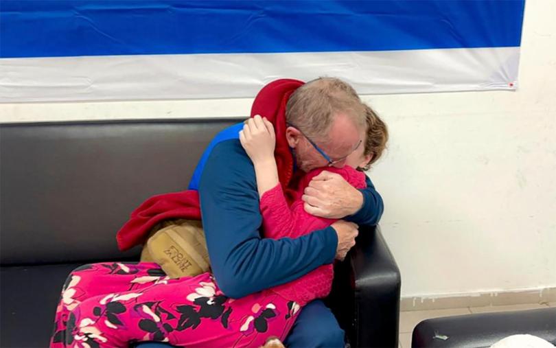 Emily Hand, right, a released hostage, reunites with her father.