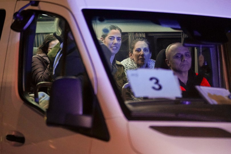 A mini-bus carrying Israeli hostages released by Hamas and Israeli military personnel arrives at the Sheba Medical Center in Ramat Gan, Israel, early Thursday, Nov. 30, 2023. International mediators on Wednesday worked to extend the truce in Gaza, encouraging Hamas militants to keep freeing hostages in exchange for the release of Palestinian prisoners and further relief from Israel's air and ground offensive.(AP Photo/Leo Correa)