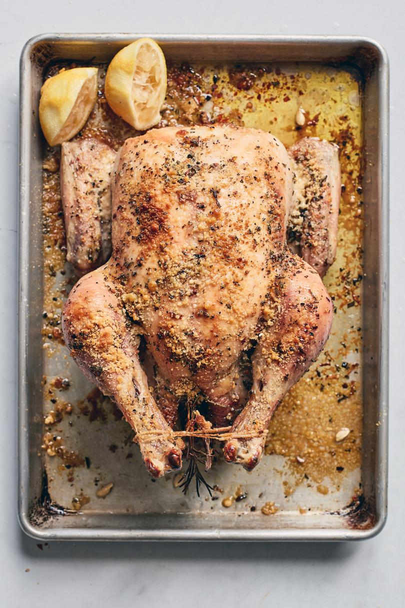 Parmesan cheese is added to the chicken skin halfway through cooking for Crispy Parmesan Roast Chicken with Lemon in New York on Jan. 8, 2020. You can rub your bird down with salt, or you can try Melissa Clark’s latest trick for an exterior that crackles like a potato chip. Food stylist: Rebecca Jurkevich. (Johnny Miller/The New York Times)