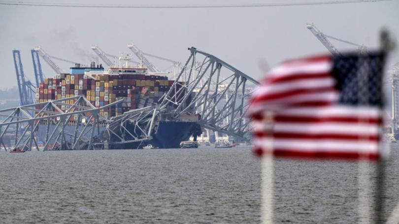 The container ship struck a bridge pylon, crumpling almost the entire structure into the water. 