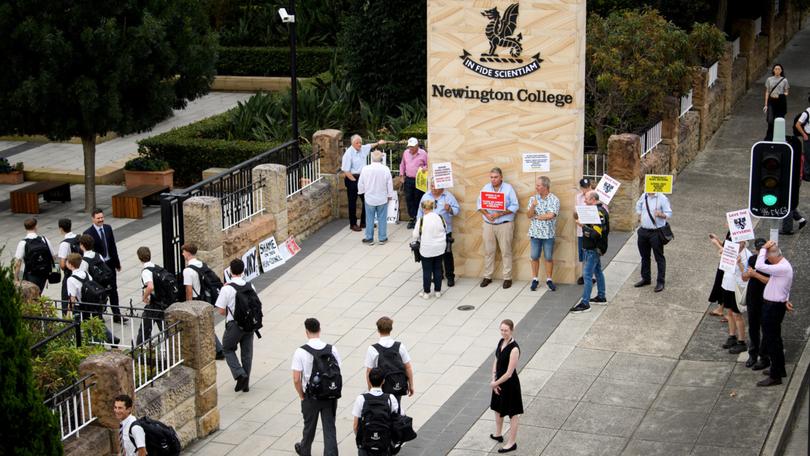 Parents and old scholars hold placards during a protest against Newington College's decision to transition to co-ed, in Sydney, Wednesday, January 31.