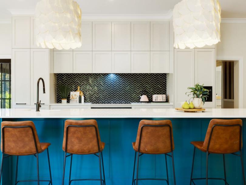 The kitchen has a large stone-top island bench.