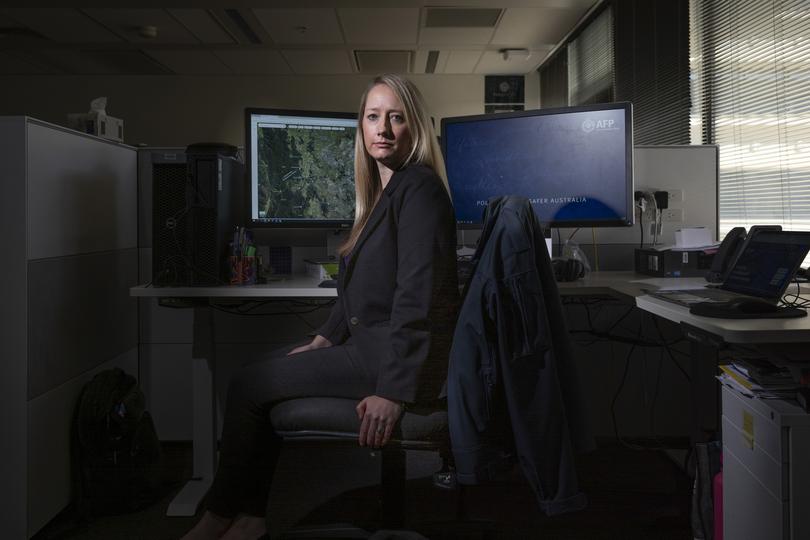 FOR THE NIGHTLY - 20240402: Kirsty Clarke, 37, is a member of the Victims Identification Unit in the Australian Federal Police, based in Canberra. Kirsty reviews visual material of child exploitation to identify victims of sexual abuse. Photo made in the office of the victims identification unit at the AFP.  Story by Kristin Shorten. Photo by Sean Davey.