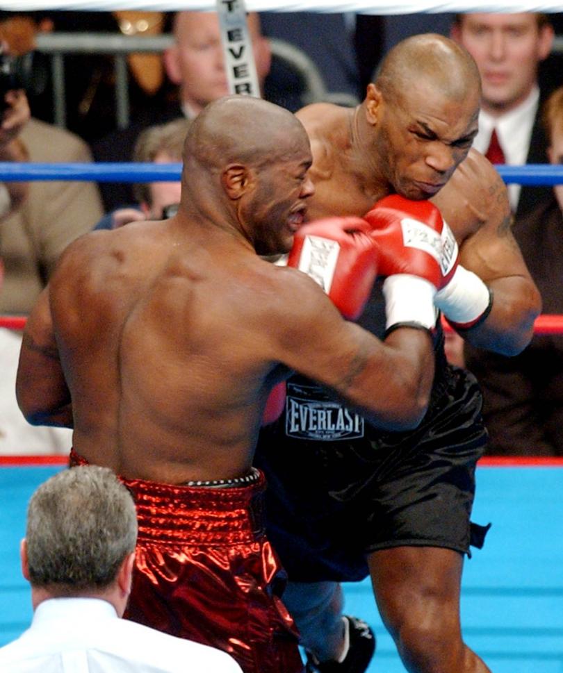 Former heavyweight champion Mike Tyson hits Clifford Etienne, with a knockout punch in the first round of their fight, Saturday night Feb. 22, 2003, in Memphis, Tenn. (AP Photo/Alan Spearman)