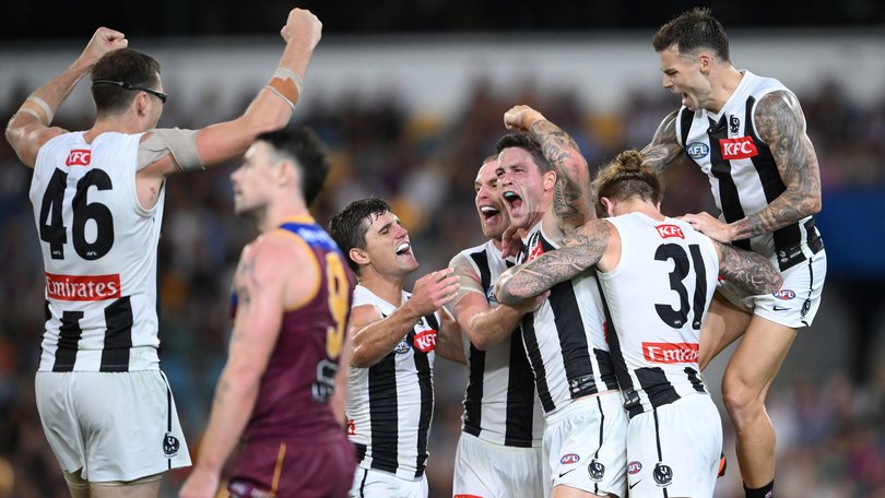 Jack Crisp celebrates kicking a goal. 