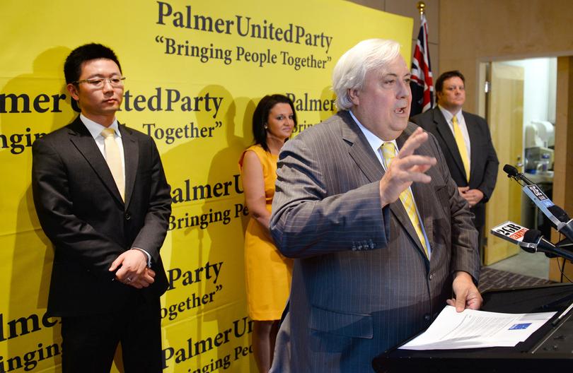 Australian mining billionaire and leader of the Palmer United Party (PUP) Clive Palmer speaks as PUP senators Dio Wang (L), Jacqui Lambie (2nd L) and Glenn Lazarus (R) listen as Palmer announces he had signed a memorandum of understanding to work together and with intentions Australian Motoring Euthusiast Party (AMEP) senator Ricky Muir to vote with the Palmer United Party in the Senate, in Sydney on October 10, 2013.  Palmer brokered a crucial alliance giving him the balance of power in Australia's new parliament, warning of a "very cold winter" if the government tries to cross him.  AFP PHOTO/William WEST