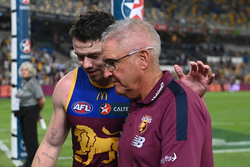 BRISBANE, AUSTRALIA - MARCH 28: Lachie Neale of the Lions walks off the field with head coach Chris Fagan after their defeat during the round three AFL match between Brisbane Lions and Collingwood Magpies at The Gabba, on March 28, 2024, in Brisbane, Australia. (Photo by Albert Perez/AFL Photos via Getty Images )
