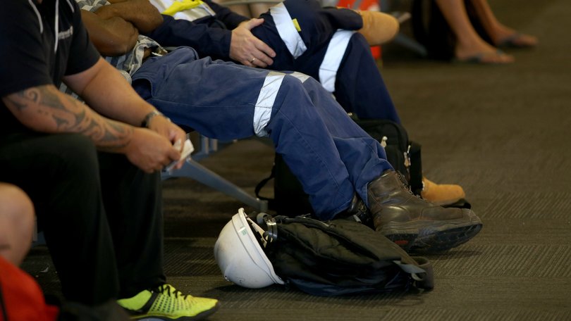 Mine workers at Perth airport ready to fly to site.