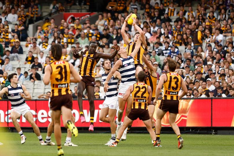 MELBOURNE, AUSTRALIA - APRIL 01: Mitch Lewis of the Hawks takes a high mark over Sam De Koning of the Cats during the 2024 AFL Round 03 match between the Hawthorn Hawks and the Geelong Cats at the Melbourne Cricket Ground on April 01, 2024 in Melbourne, Australia. (Photo by Michael Willson/AFL Photos via Getty Images)