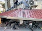 A man checks a partially collapsed building in Hualien after the 7.2 magnitude quake.