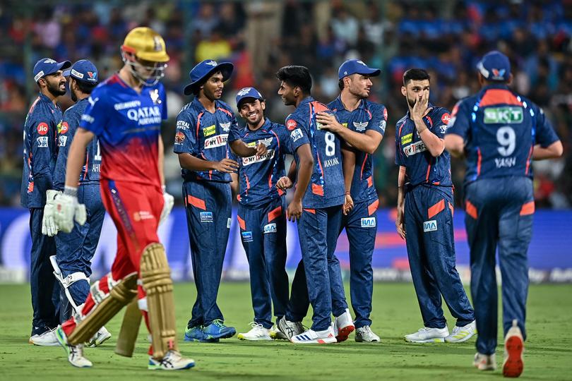 Lucknow Super Giants' Mayank Yadav (C) celebrates with teammates after taking the wicket of Royal Challengers Bengaluru's Cameron Green (3L) during the Indian Premier League (IPL) Twenty20 cricket match between Royal Challengers Bengaluru and Lucknow Super Giants at the M Chinnaswamy Stadium in Bengaluru on April 2, 2024. 