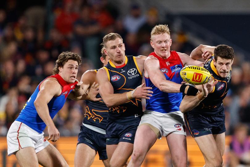 Rory Laird, Clayton Oliver and Chris Burgess compete for the ball.