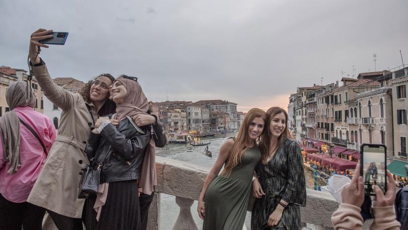 Visitors to Venice, Italy, which attracts millions of tourists each year, May 4, 2022. Starting on April 25, 2024, tourists intending to visit the city on busy dates will be required to register on a website, and those coming for a single day will have to pay a little over $5. 